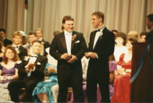 Two friends accept an award (for players from the football team?)